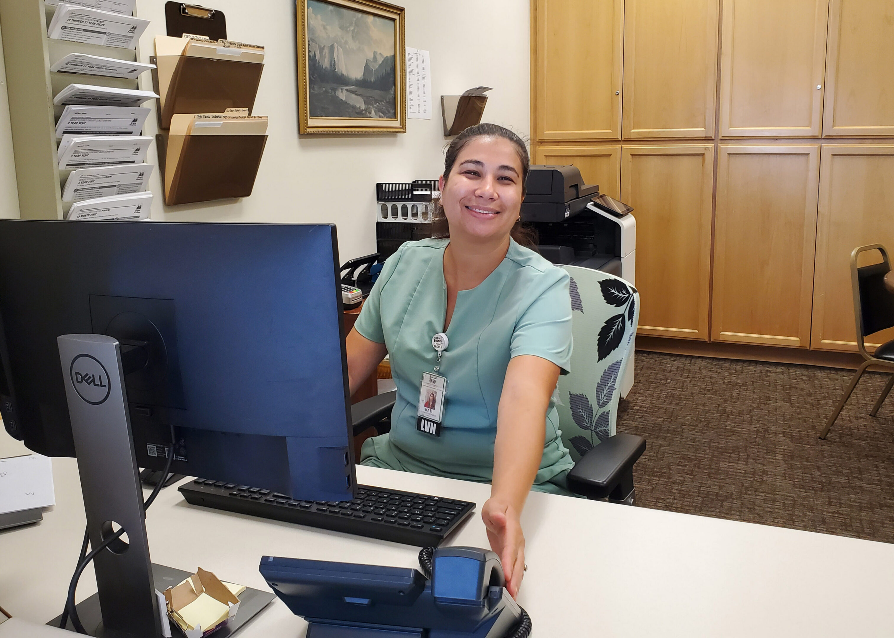 Pictured is District Quality Nurse Kati Baca RN, BSN, sitting at the front desk of the JCF Northside Clinic. (Submitted photo).