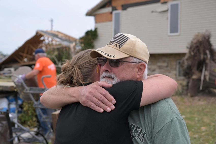 Don Wilson, a retired Navy veteran in Menasha now missing the side of his house, hugs Joni Byker, director of Disaster Relief for Samaritan's Purse. Wilson said having the Samaritan's Purse volunteers help him was "living proof that God exists." | Samaritan's Purse