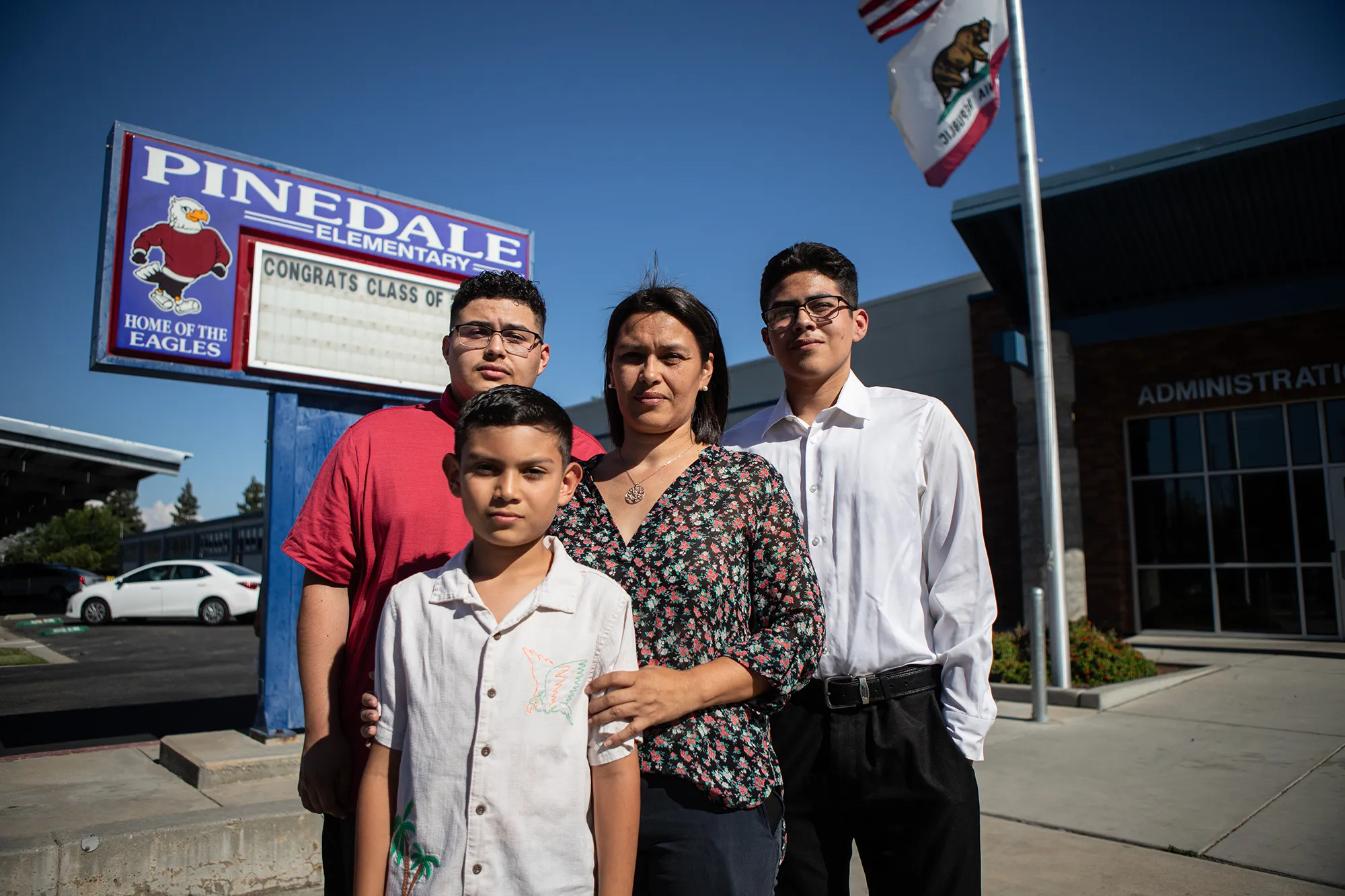 Tania Galeana-King and her three sons at Pinedale Elementary School in Fresno on June 1, 2026. From left, Corvin Galeana, Sheldon King, Tania Galeana-King, and Evan King. Photo by Larry Valenzuela, CalMatters